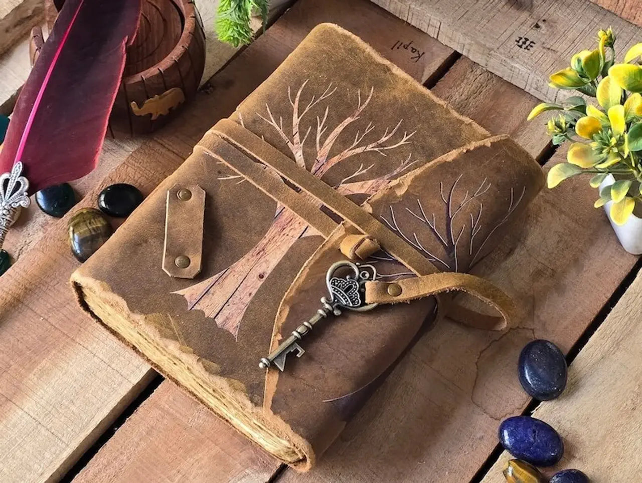 LAMAKHA tree of souls vintage leather journal angled view — painted winter tree, antique bronze skeleton key charm, distressed camel leather, witchy journal refillable journal, making field notes, leather cover custom leather notepad, leather journal with key
best gift for her, sketching, sketchbook, grawing, daily diary, emotions, scrapbook, photos album, luxury leather journals, embossed leather notebook